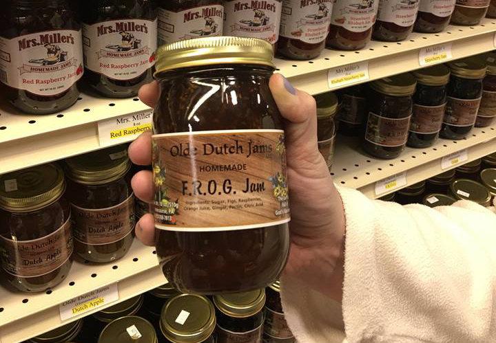 unique of farmers' market food: close-up of hand holding a jar of FROG jam