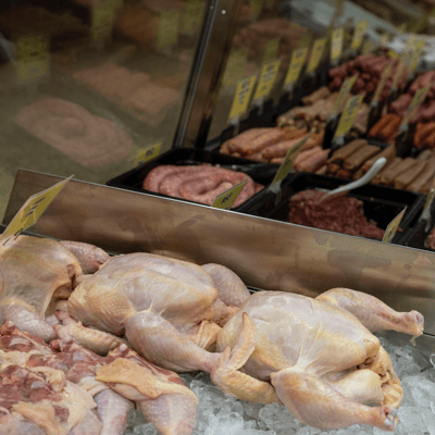 Raw chicken and meat behind Patch's Poultry