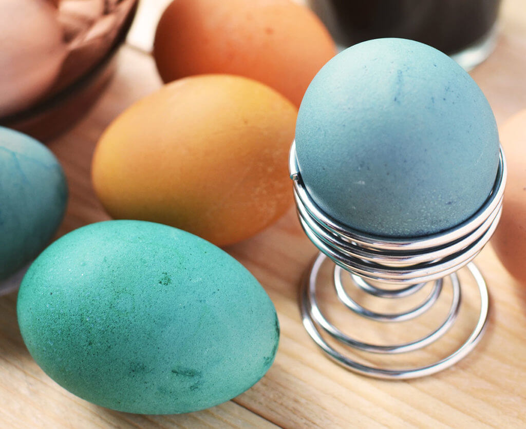 colorfully dyed Easter eggs on a wooden tabletop