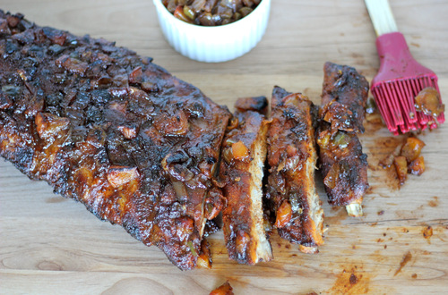 BBQ peach ribs on a wooden cutting board