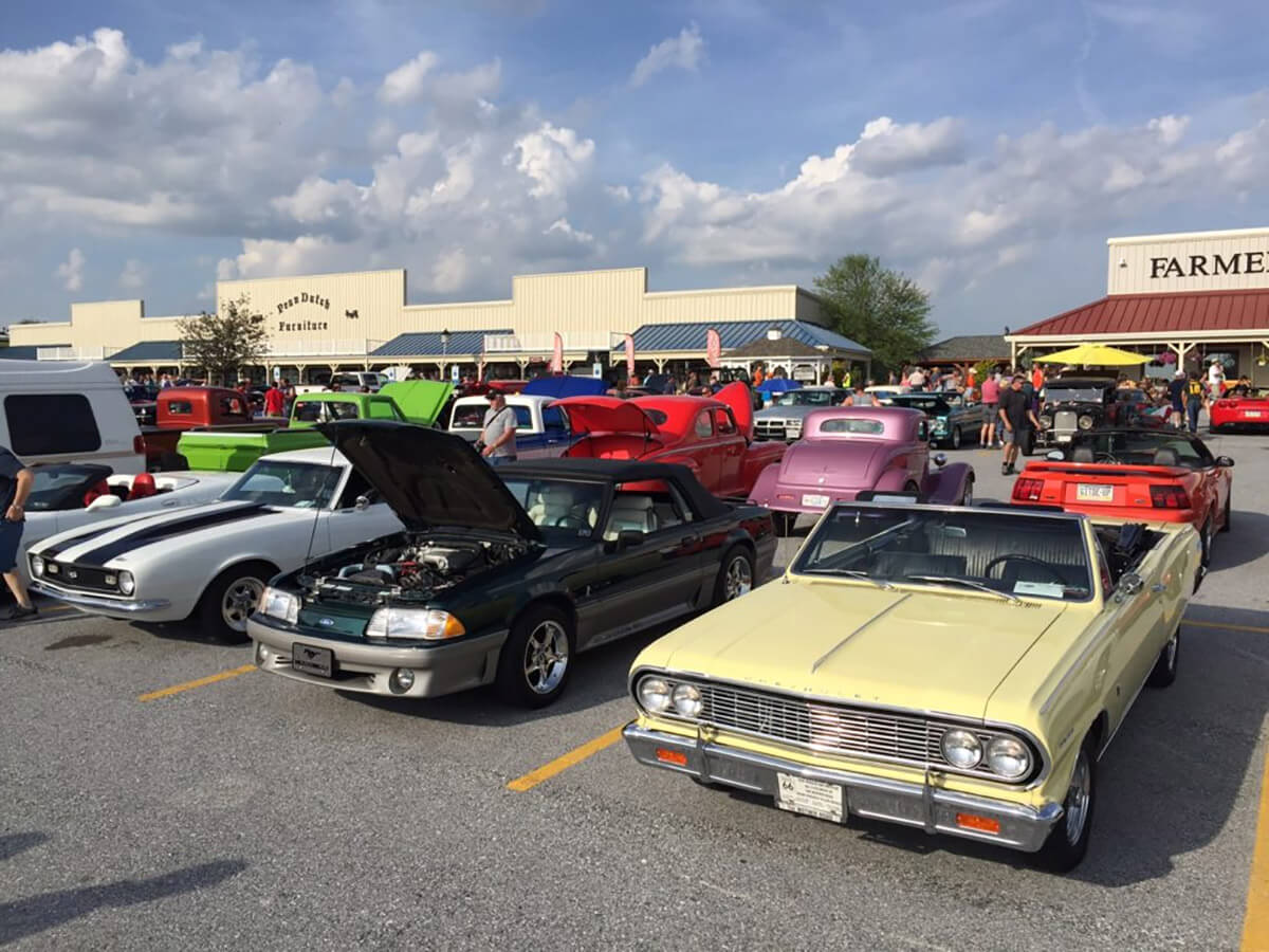 A group of cars parked in a parking lot at Markets at Shrewsbury, Glen Rock, York County, Pennsylvania during a car show.