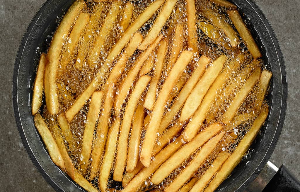 Homemade fresh cut french fries crisping in a fryer