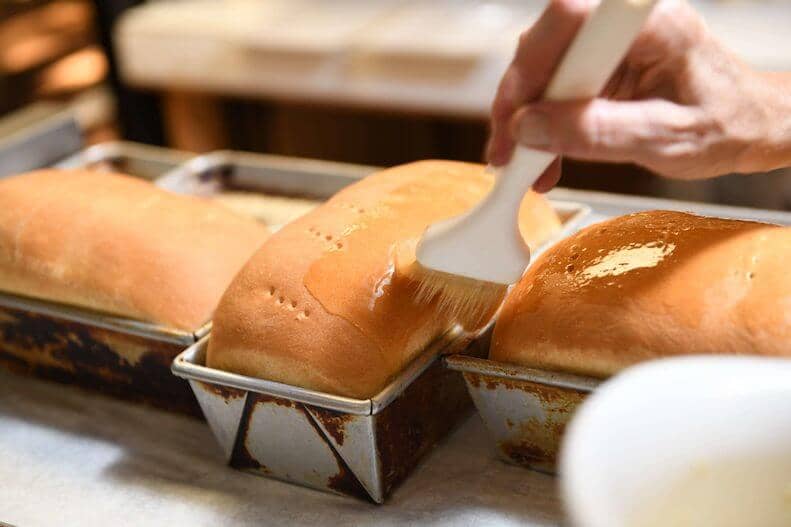 buttering freshly baked amish bread