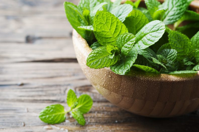 Fresh mint inside a wooden bowl.