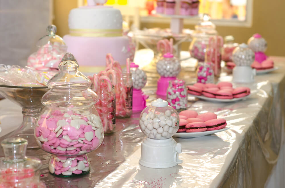 A wedding candy bar full of pink-themed candy for guests to grab.