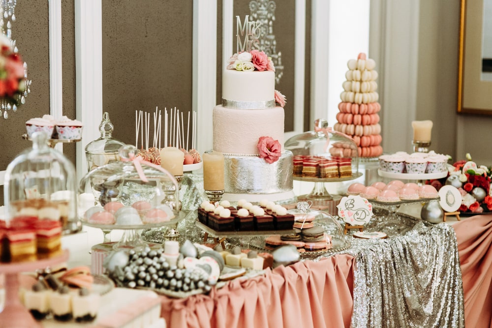 A wedding reception candy and dessert bar table.