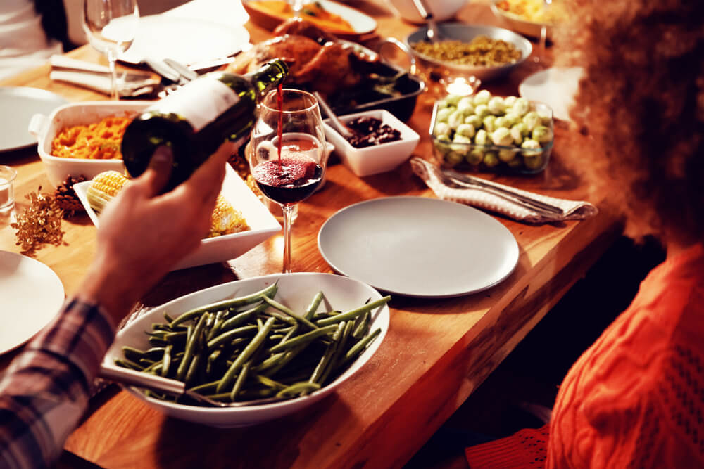 A family passes sides around the Thanksgiving table.