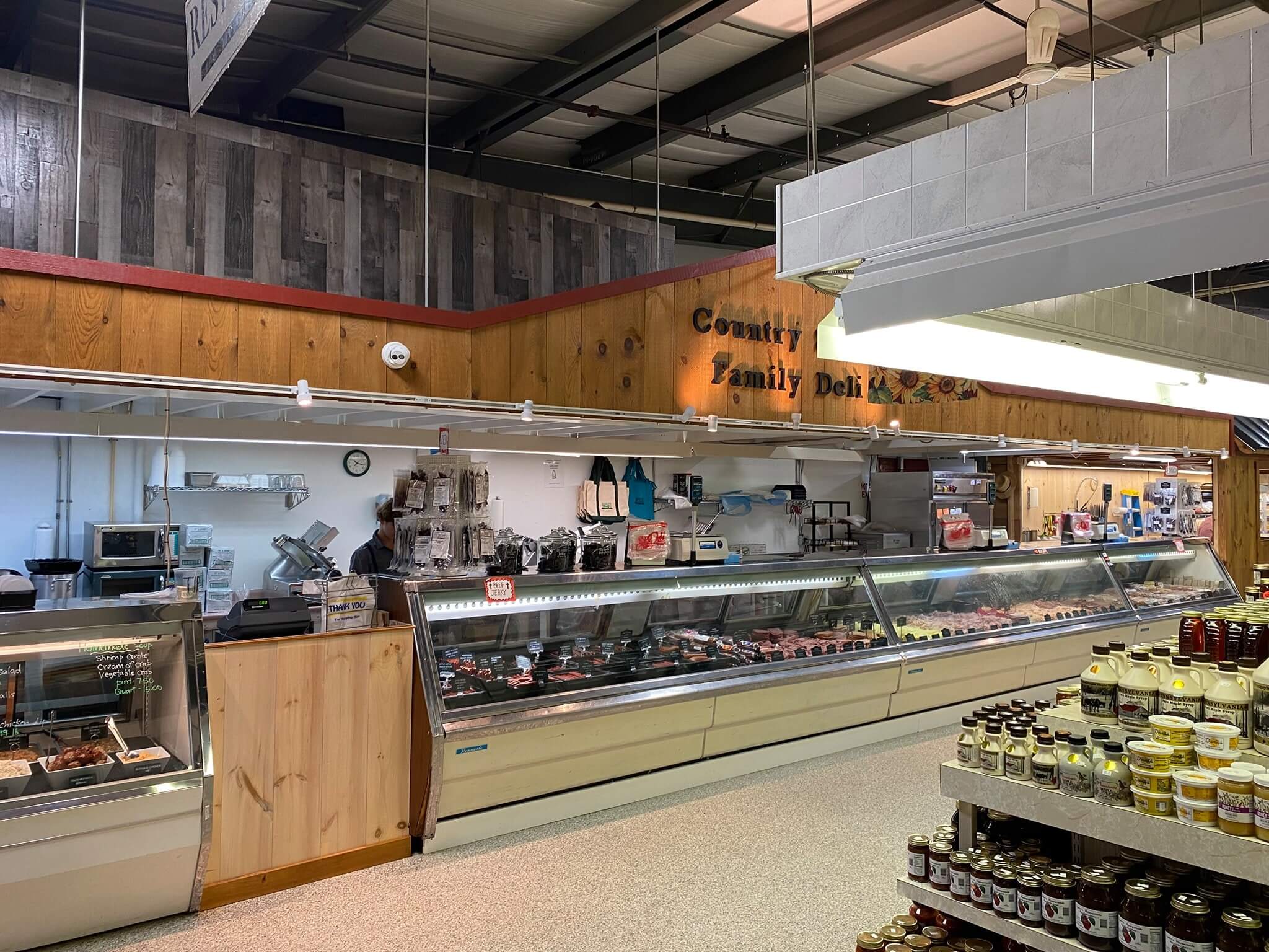 Meat and cheese are displayed at a local deli in the Markets