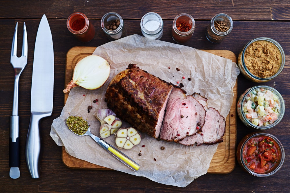 One of the types of pork cuts sits on a cutting board.