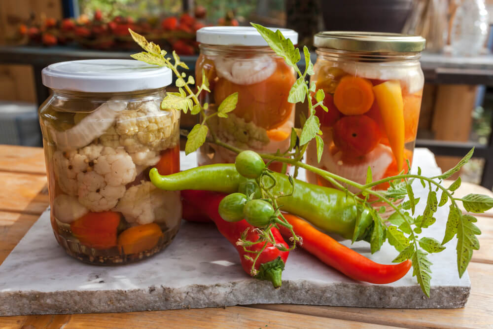 an assortment of vegetables being preserved in a jar