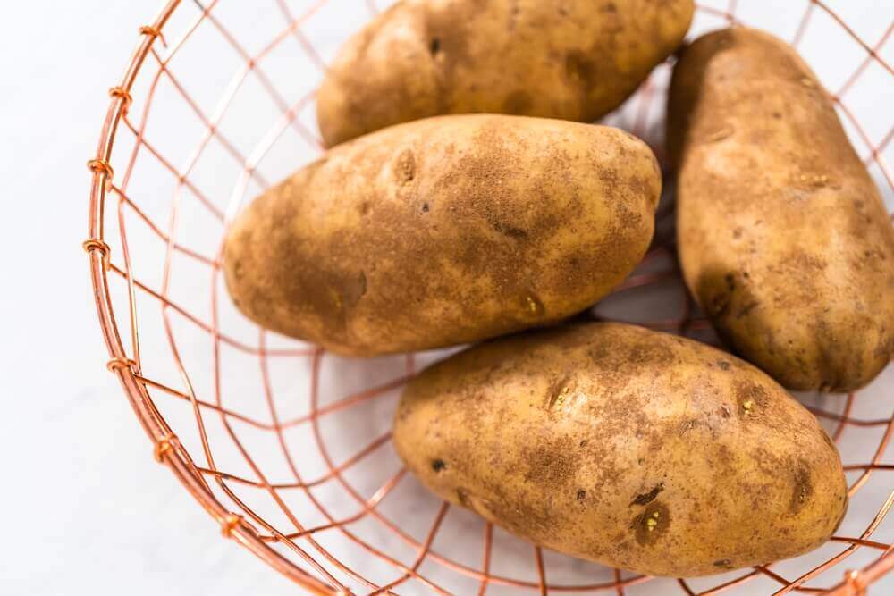 Basket of large russet potatoes