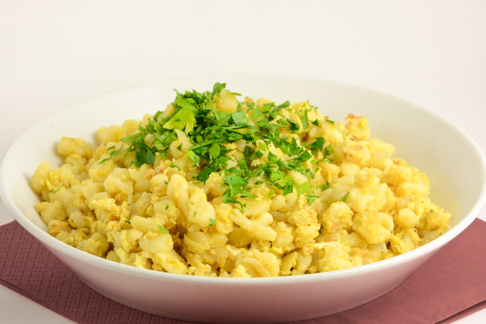 Close-up of egg dumplings in a white bowl and background.