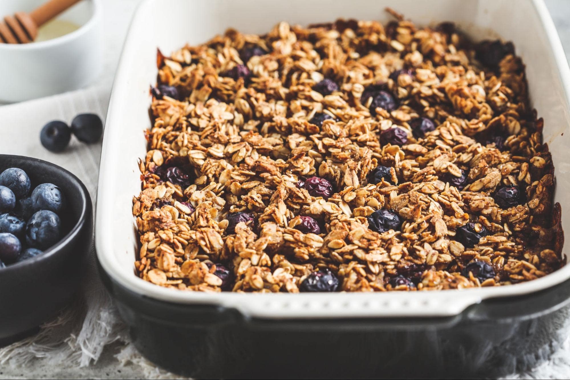 Baked oatmeal with blueberries in dish, showcasing healthy meals for large families on a budget