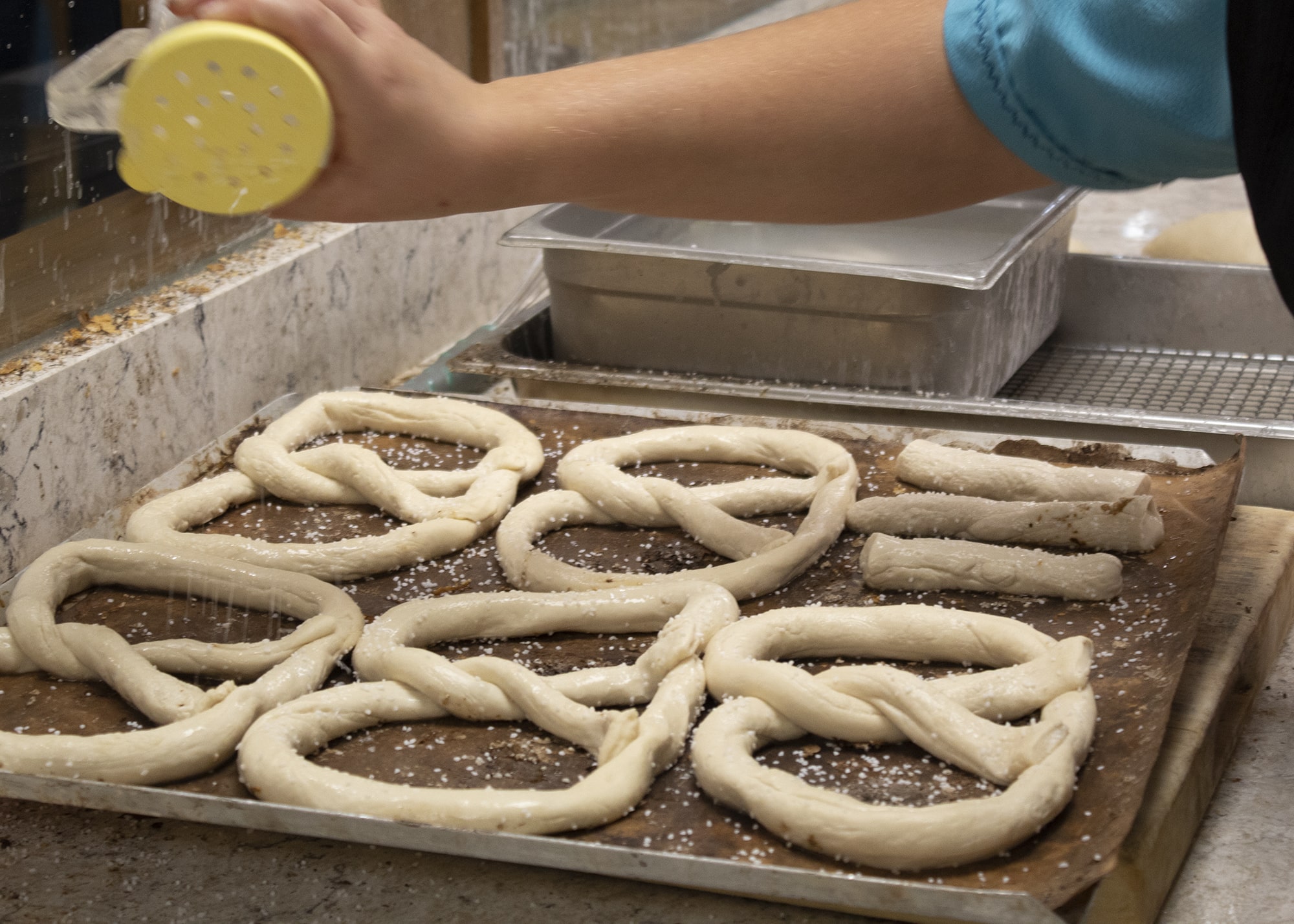 Twisted pretzel dough being prepared for large group on a budget