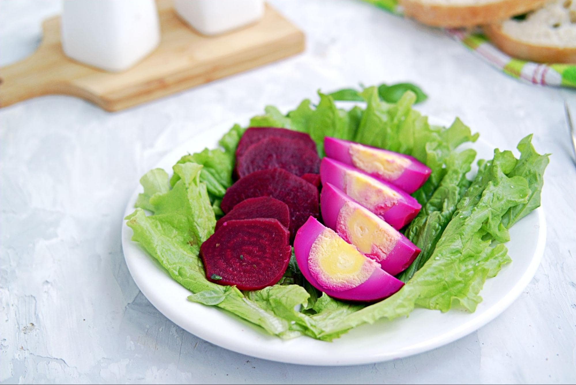 recipe for large families on a budget featuring red beet eggs on a plate of lettuce 